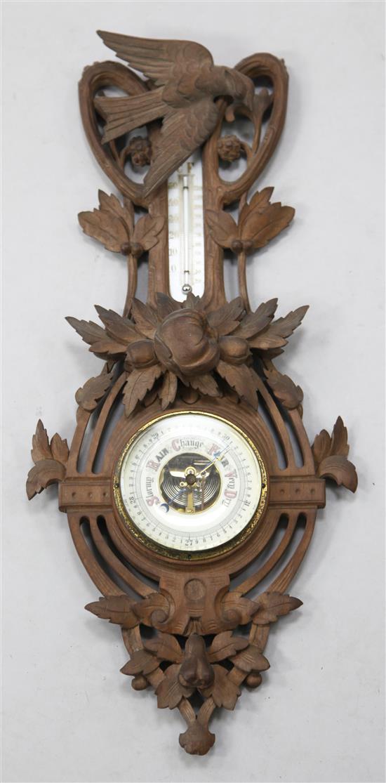 A Black Forest carved wood aneroid barometer, 2ft